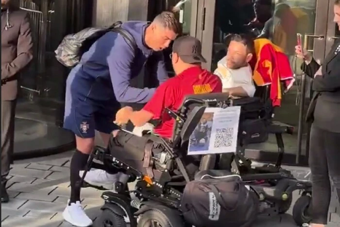 Ronaldo approached the fans in wheelchairs, but one of them hit him in the leg